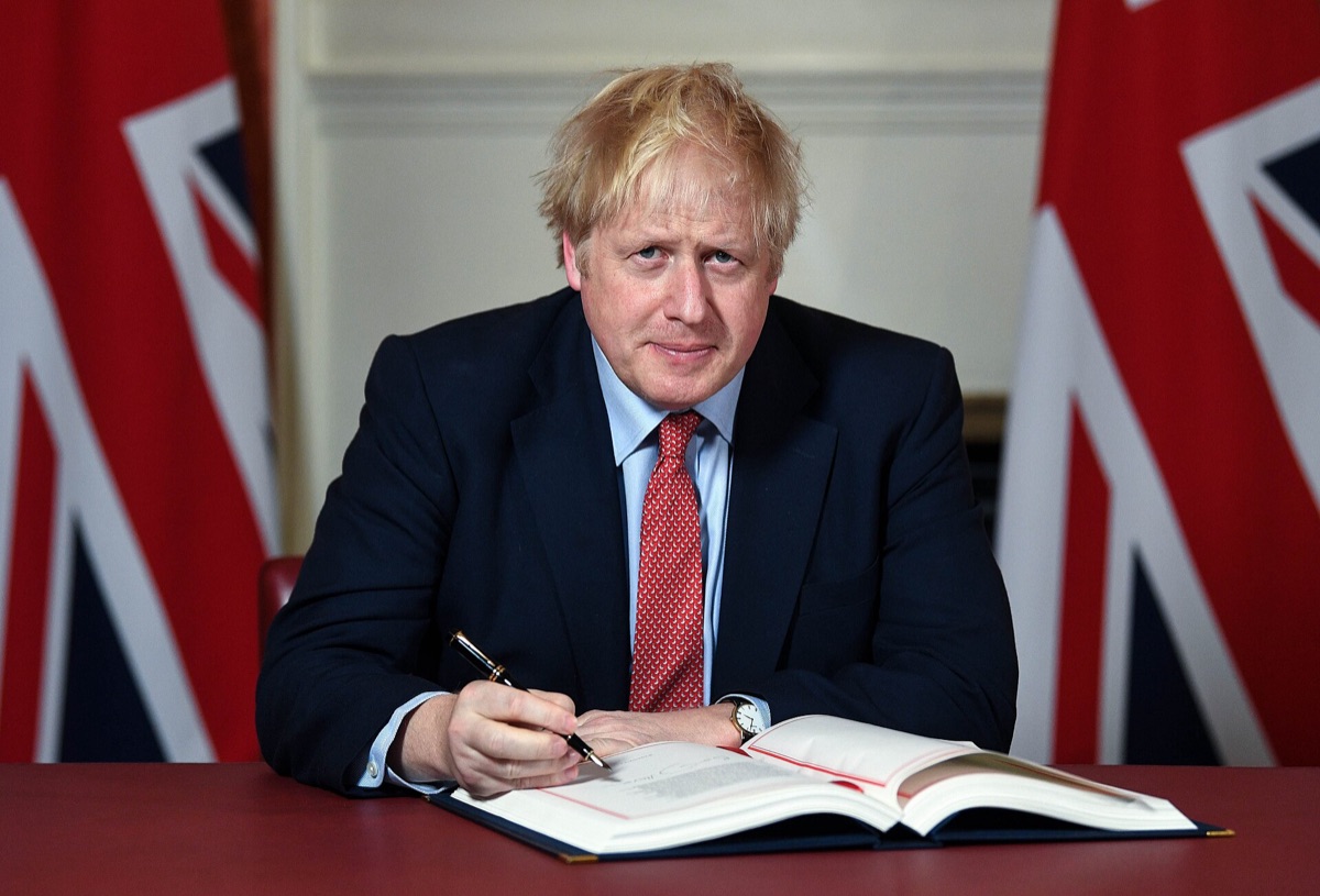 Close-up of a blue document with UK and EU flags on the cover